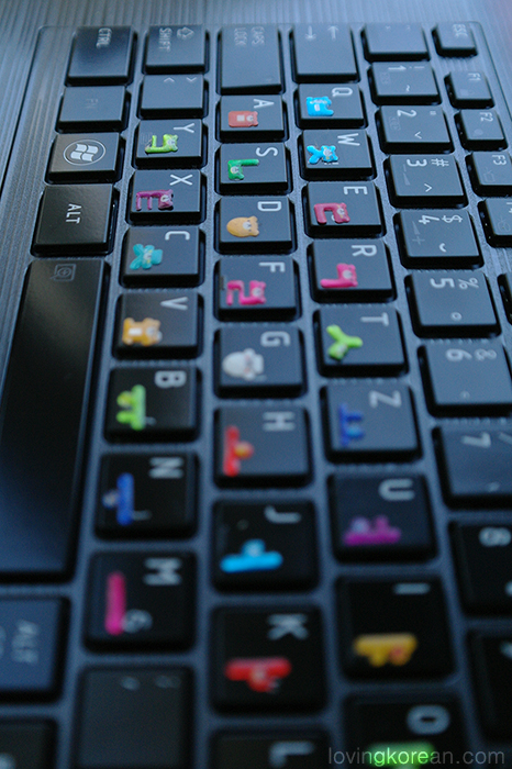 Cute Korean alphabet bear stickers on dark keyboard